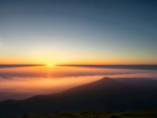 Sunrise over volcanic ridges above a layer of cloud