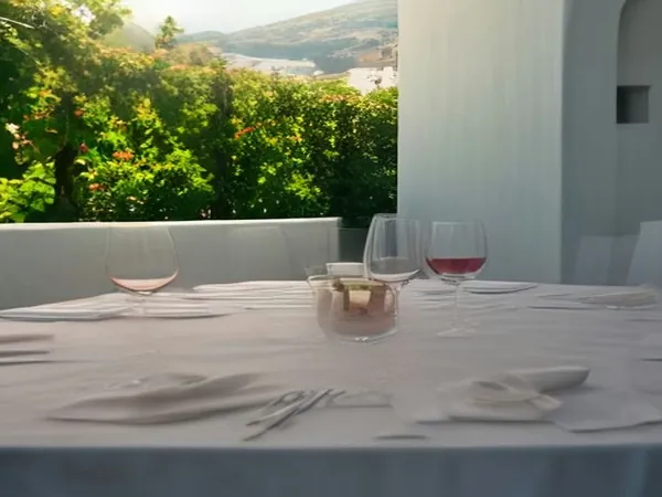 Wine glasses on a terrace overlooking vineyards