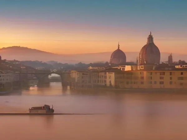 Florence's terracotta rooftops and cathedral dome seen across the Arno at sunset
