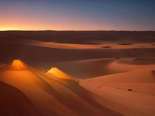 Desert dunes glowing orange at sunset