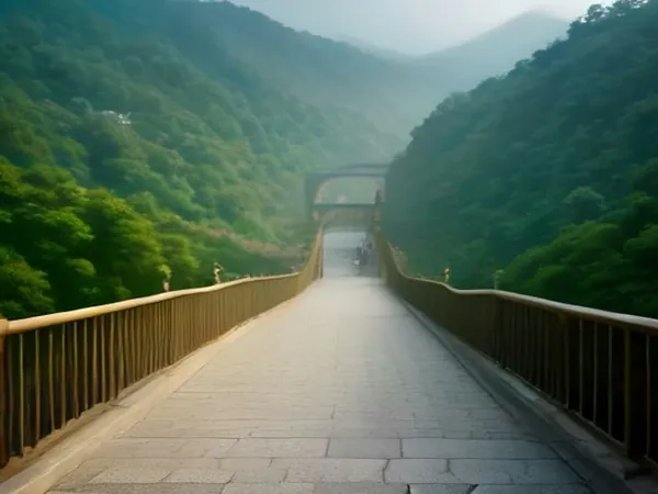 A footbridge leading into misty green mountains