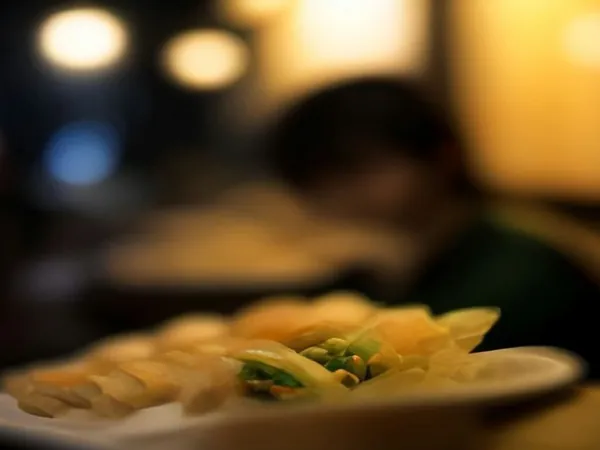 A plate of street food under warm night lights